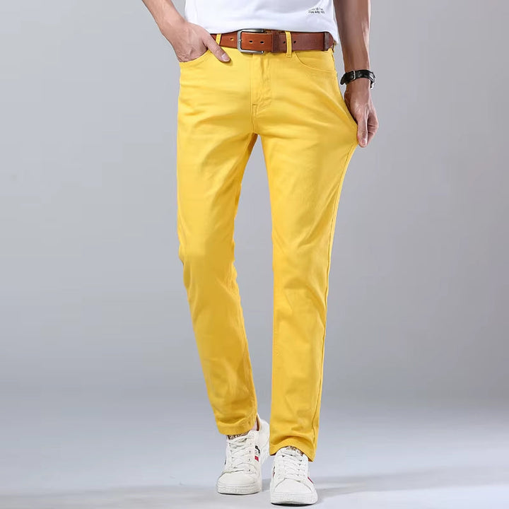Man sitter i mörkblå stretchjeans slim fit, visar komfort och rörelsefrihet, perfekta vardagsjeans