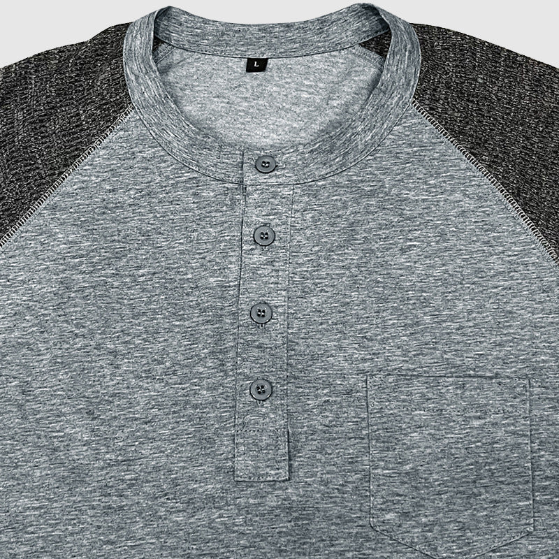 Modell bärande en herr tvåfärgad Henley skjorta, framhäver avslappnad passform för sommarstil.