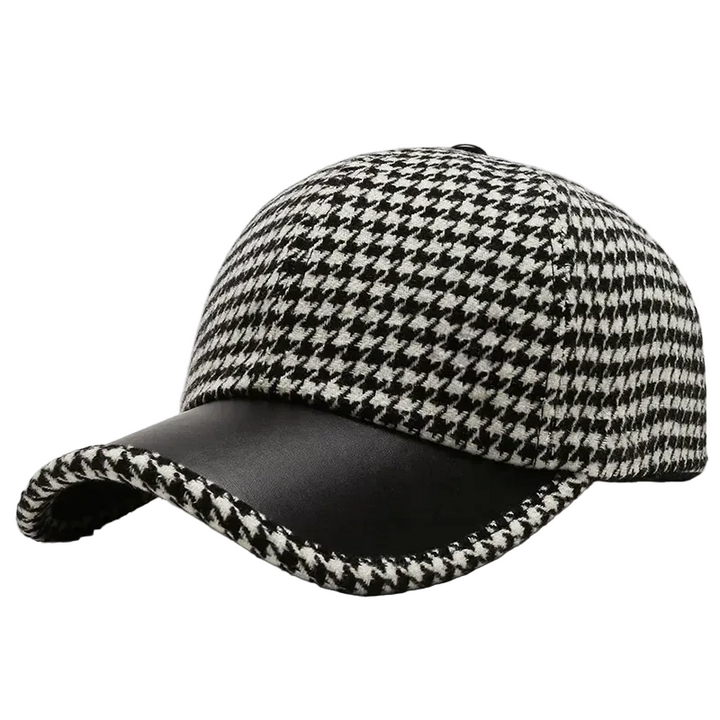 Herrkeps i klassisk houndstooth med svarta konstläderdetaljer på brättet, stilren herrhatt.