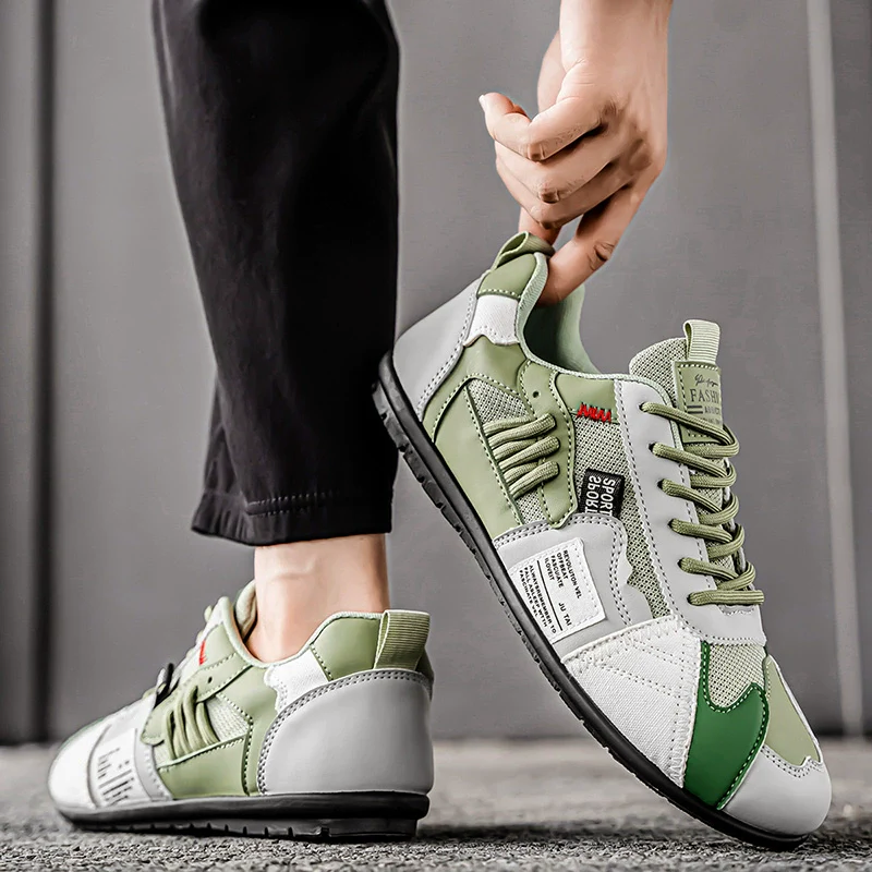 Herrskor stilfullt framifrån, visar de livfulla färgblocken och skiktade designen på sneakers.