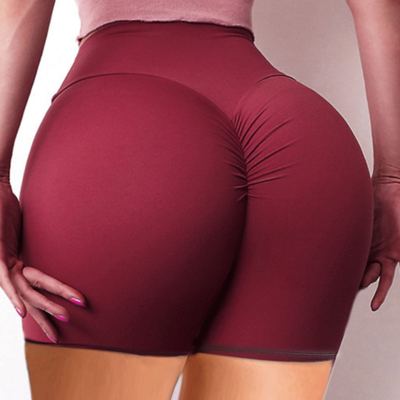 "Höga yogashorts för kvinnor, veckad design, hög midja, mörk färg, komfort och rörlighet, perfekt för träning."
