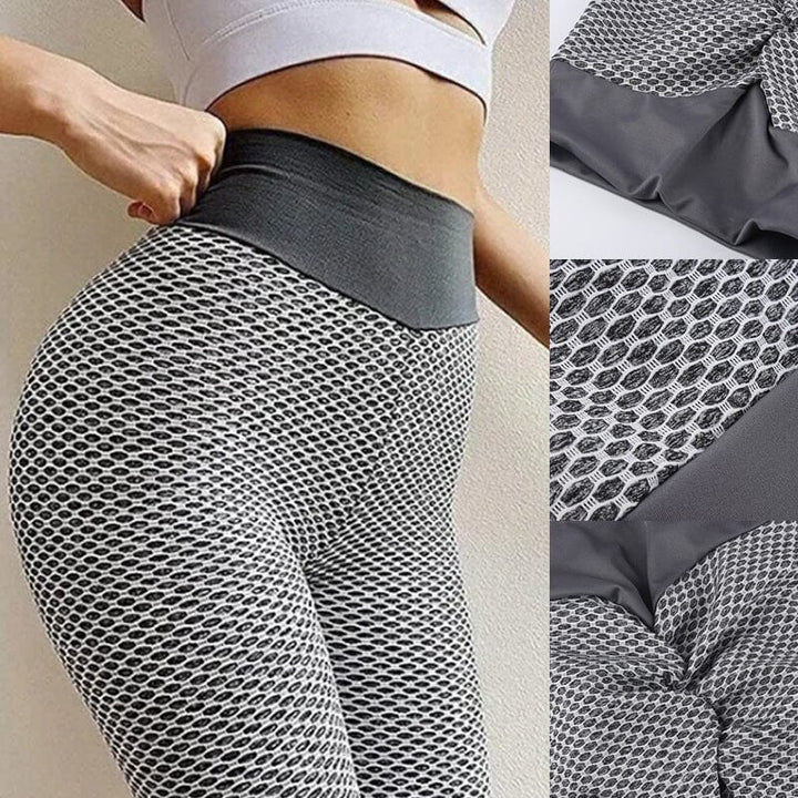 Högmidjade dam yoga leggings med rumplyft effekt och brett midjeband, i grå färg, för komfort och stil vid träning.