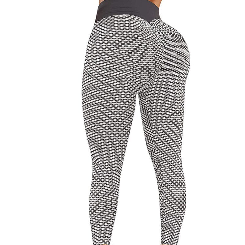 Högmidjade dam yoga leggings med rumplyft effekt och brett midjeband, i grå färg, för komfort och stil vid träning.