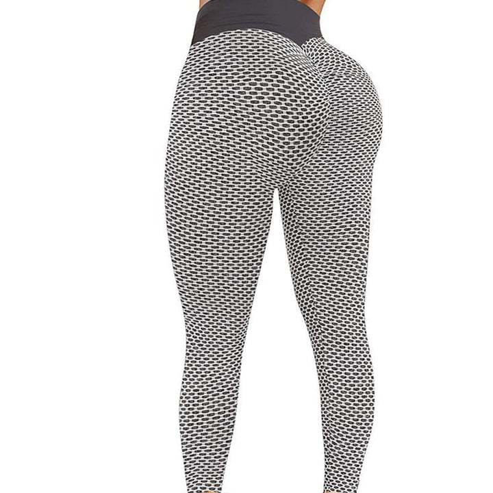 Högmidjade dam yoga leggings med rumplyft effekt och brett midjeband, i grå färg, för komfort och stil vid träning.