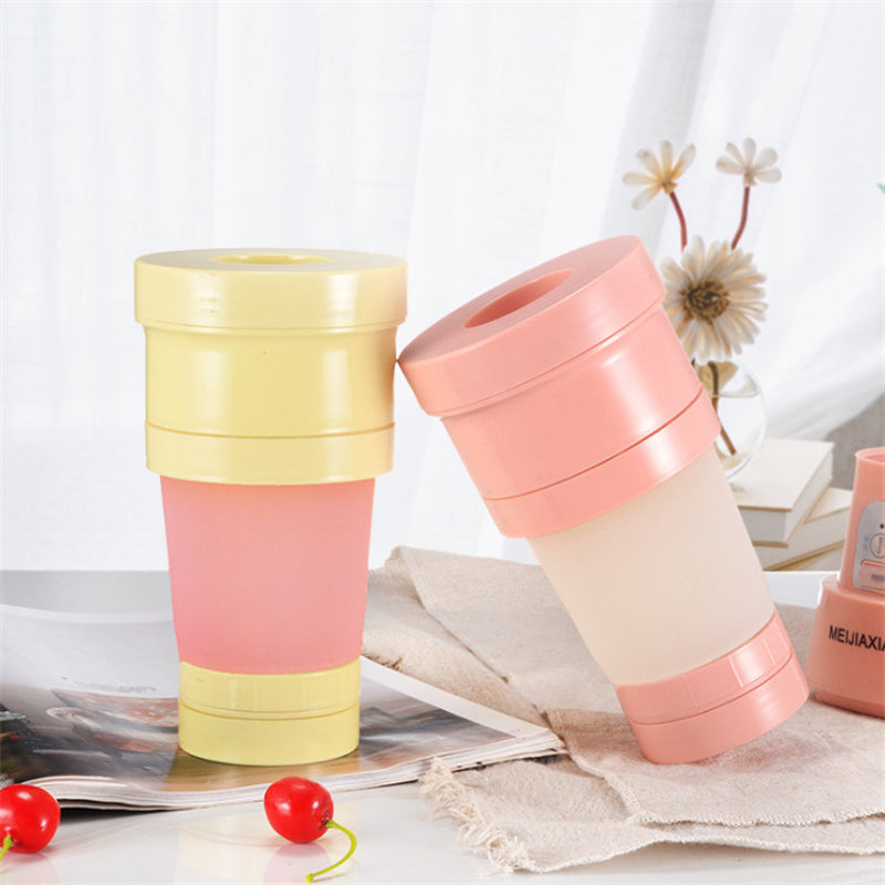 "Hopfällbar mini-juicepresskopp i rosa, kompakt design med rostfritt stålblad, idealisk för hälsosamma drycker på språng."
