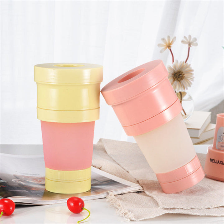 "Hopfällbar mini-juicepresskopp i rosa, kompakt design med rostfritt stålblad, idealisk för hälsosamma drycker på språng."