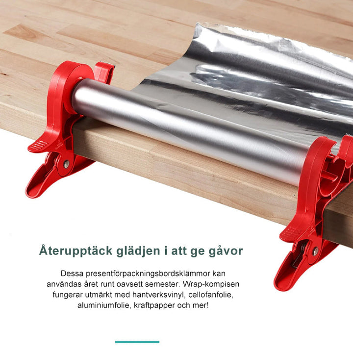 "Inslagningverktyg i röd och grå plast för presentinpackning, justerbar för olika pappersstorlekar."