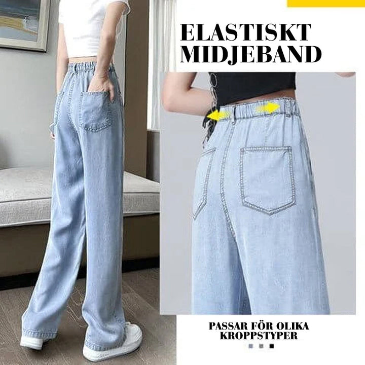 "Jeans med vida ben för kvinnor i blått lyocellmaterial med hög midja och raka ben, ger en smickrande och bekväm stil."