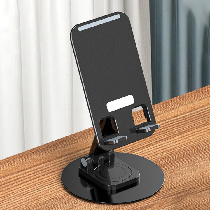 Justerbar 360° rotationshållare i metall med halksäkra kuddar för telefon/surfplatta, elegant och kompakt design.