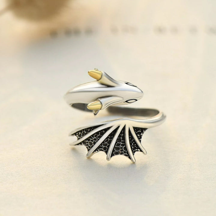 "Justerbar damring i silver med detaljrik drakdesign, symboliserar styrka och elegans, perfekt accessoar."