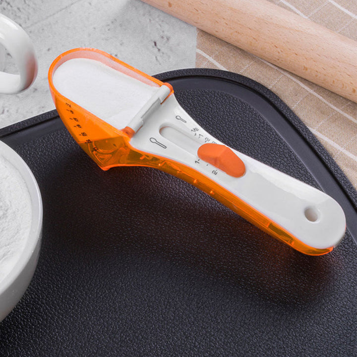 "Justerbar måttsked för kök med ergonomisk design och grön färg, perfekt för exakt mätning i matlagning och bakning."