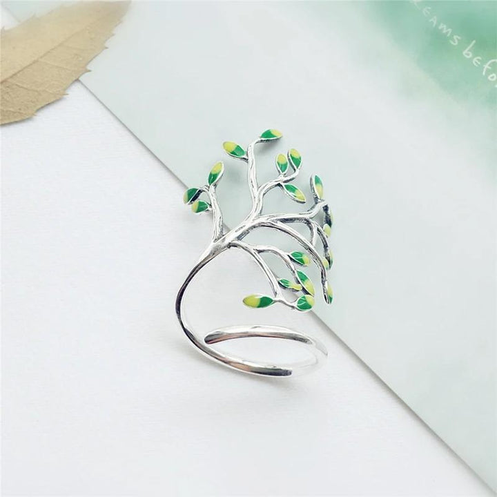 Justerbar olivträd ring i silver med gröna blad, damaccessoar som symboliserar fred och skönhet.