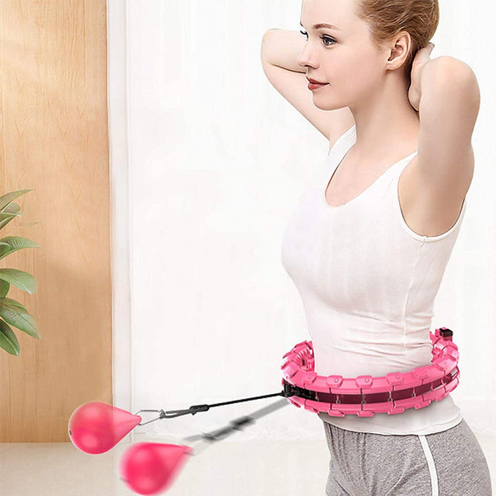 "Justerbar rosa och lila hula hoop i plast, 24 sektioner, för effektiv hemmaträning mot kaloriförbränning."