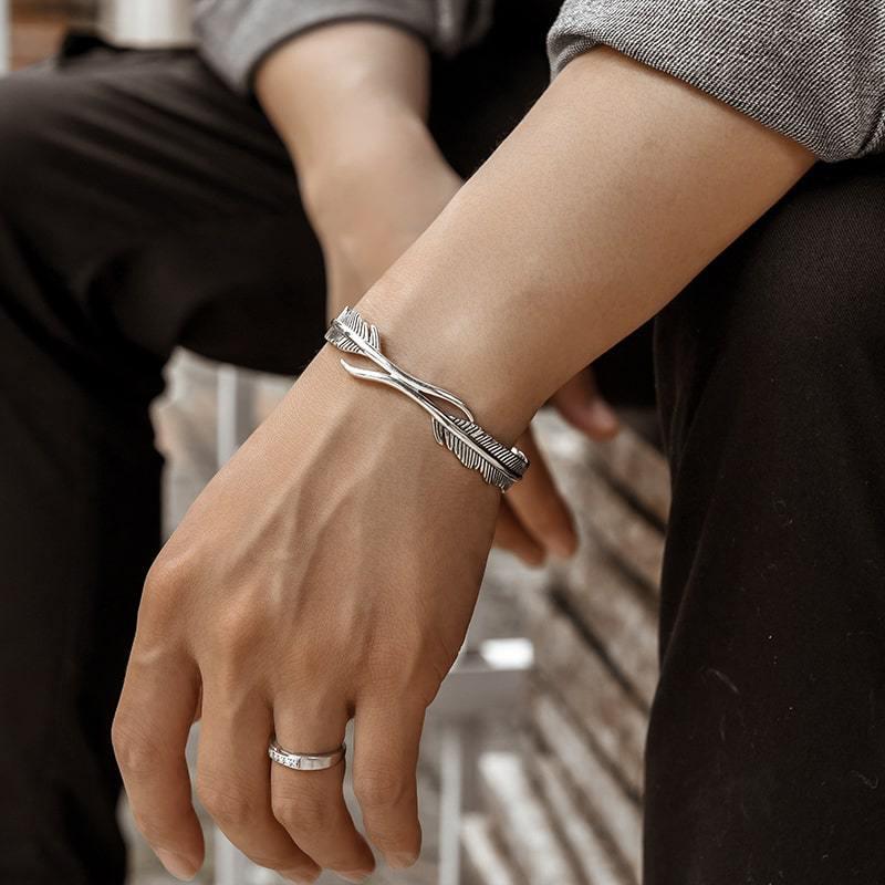 "Justerbart silverfjäderarmband för kvinnor, nickelfritt och elegant design med symboliskt fjädermotiv."