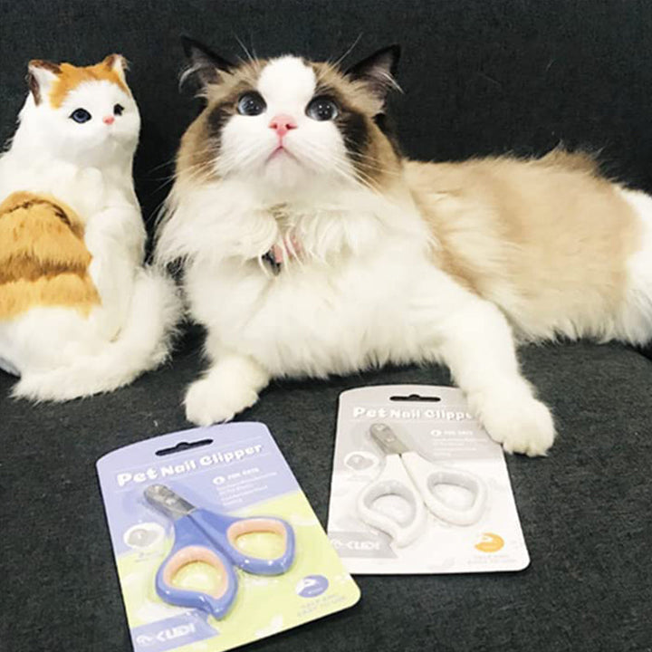 "Kattens säkra nagelklippare med rund håldesign, off-white och lila rosa, för bekvämt och tryggt klippande av klor."