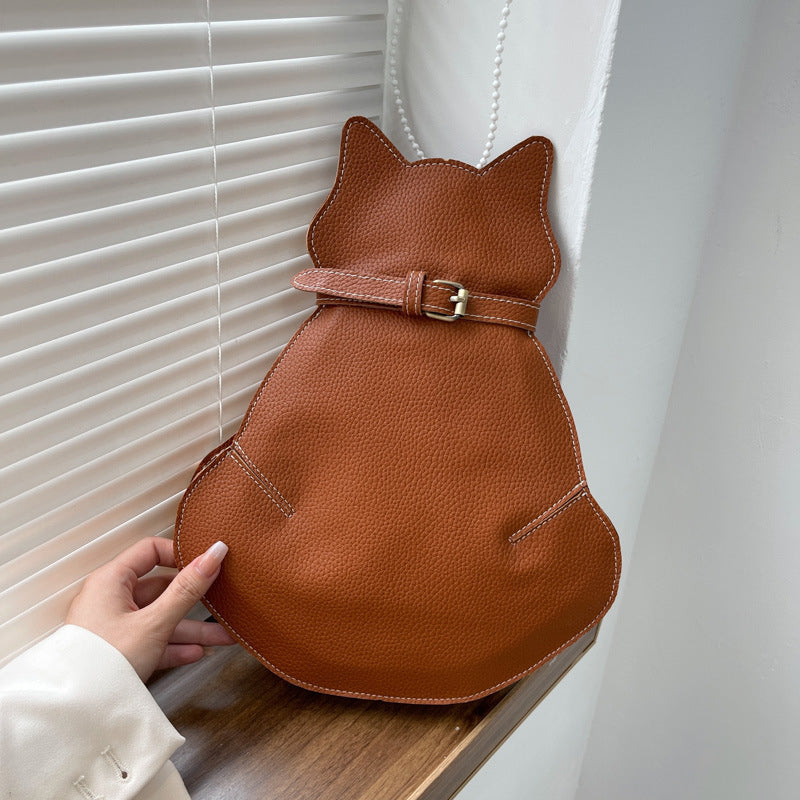 "Kattformad korsväska i svart PU-läder för kvinnor, unikt kattdesign, stilren och rymlig accessoar."