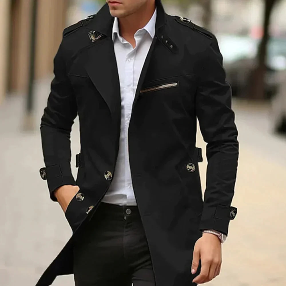 Man bär stilren herrtrenchcoat i klassisk färg. Elegant höstmode, idealisk för stadsmiljö.