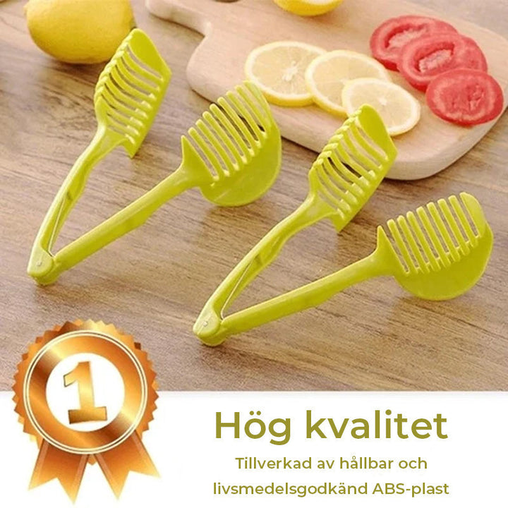 "Köksskärare i grön och svart ABS-plast, ergonomiska handtag, skär frukt och grönsaker snabbt och säkert."