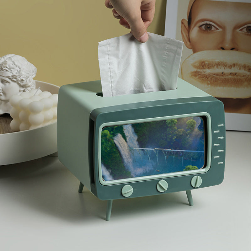 "Kreativ retro TV-servettlåda med mobilhållare i pastellfärger, nostalgi design för smart och stilren inredning."