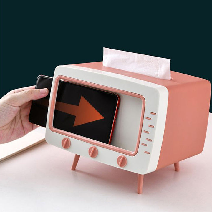 "Kreativ retro TV-servettlåda med mobilhållare i pastellfärger, nostalgi design för smart och stilren inredning."