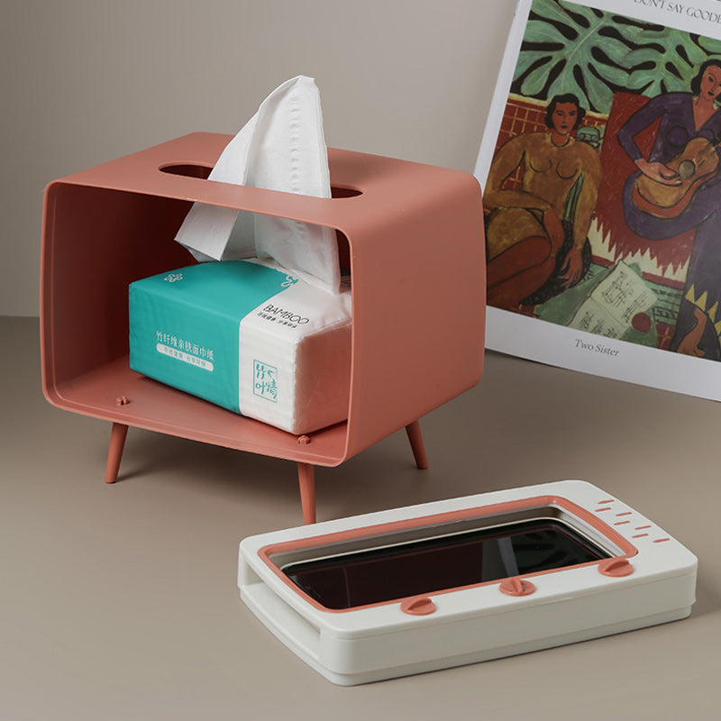 "Kreativ retro TV-servettlåda med mobilhållare i pastellfärger, nostalgi design för smart och stilren inredning."