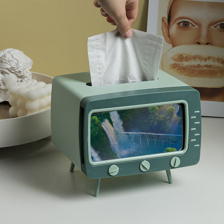 "Kreativ retro TV-servettlåda med mobilhållare i pastellfärger, nostalgi design för smart och stilren inredning."