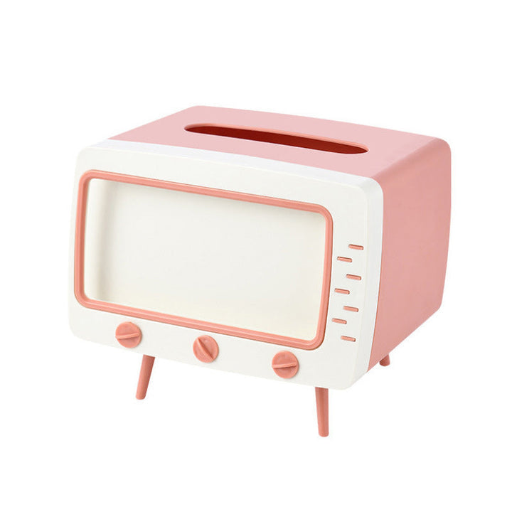 "Kreativ retro TV-servettlåda med mobilhållare i pastellfärger, nostalgi design för smart och stilren inredning."