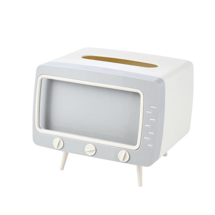"Kreativ retro TV-servettlåda med mobilhållare i pastellfärger, nostalgi design för smart och stilren inredning."