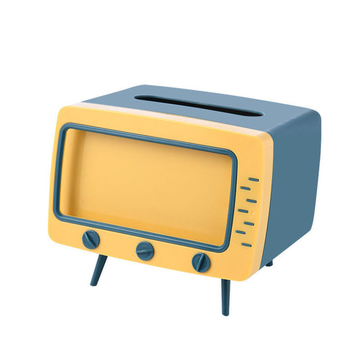 "Kreativ retro TV-servettlåda med mobilhållare i pastellfärger, nostalgi design för smart och stilren inredning."