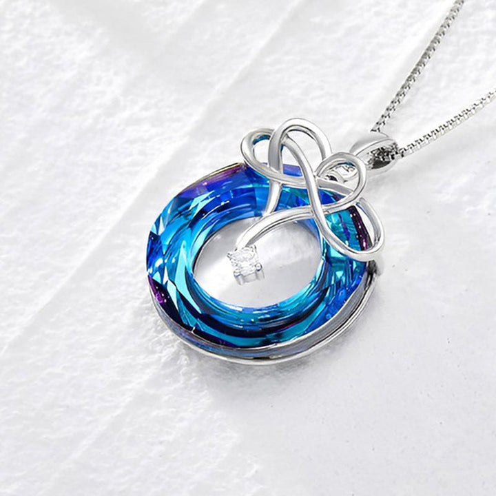 "Kvinna oändlighet halsband & örhängen set i silver och blått, elegant smyckesdesign för modern stil och tidlös charm."