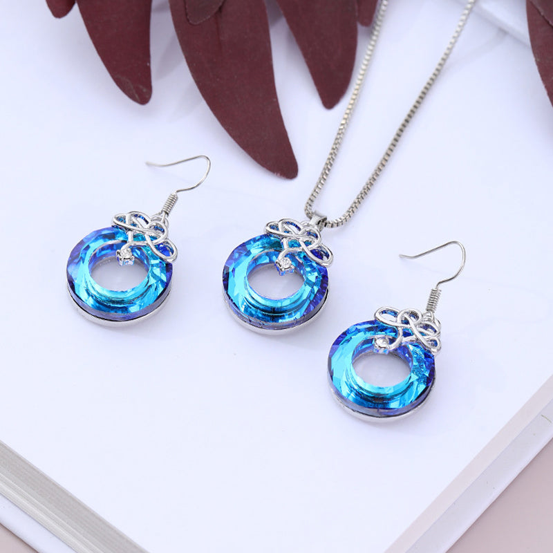 "Kvinna oändlighet halsband & örhängen set i silver och blått, elegant smyckesdesign för modern stil och tidlös charm."
