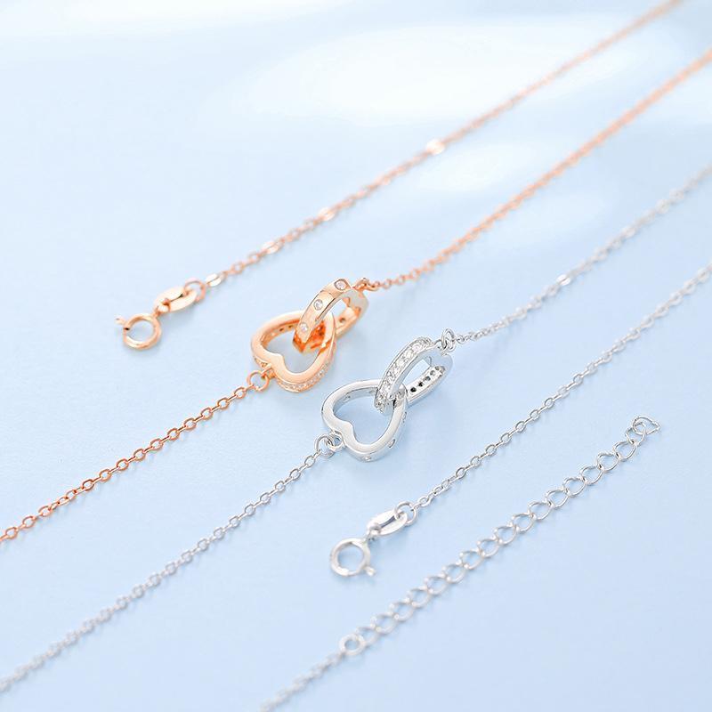 "Kvinnors halsband med rosguld/silver hjärthänge, zirconia-stenar, justerbar kedja; evig kärlek symboliserad."
