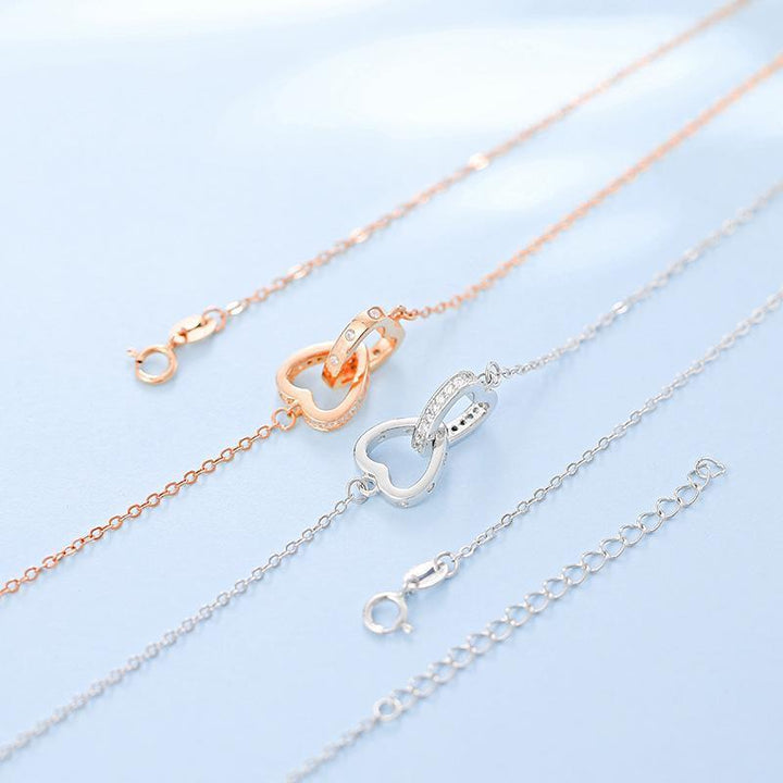 "Kvinnors halsband med rosguld/silver hjärthänge, zirconia-stenar, justerbar kedja; evig kärlek symboliserad."
