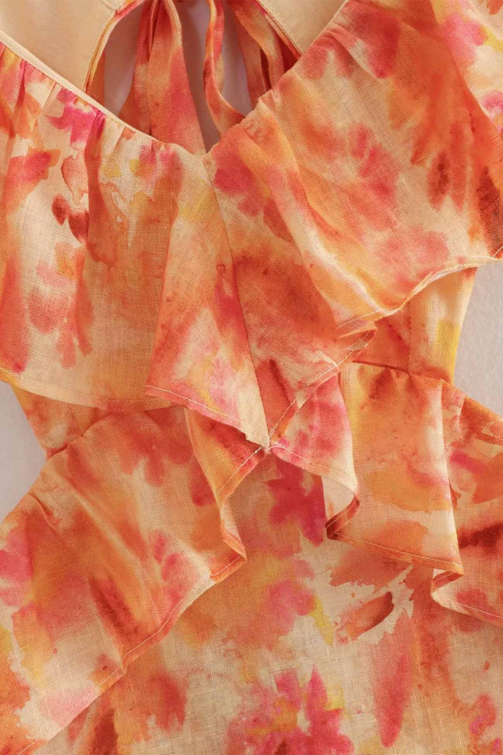 Feminin och elegant: Blommig maxiklänning i orange och blått med volanger för damers sommarstil.