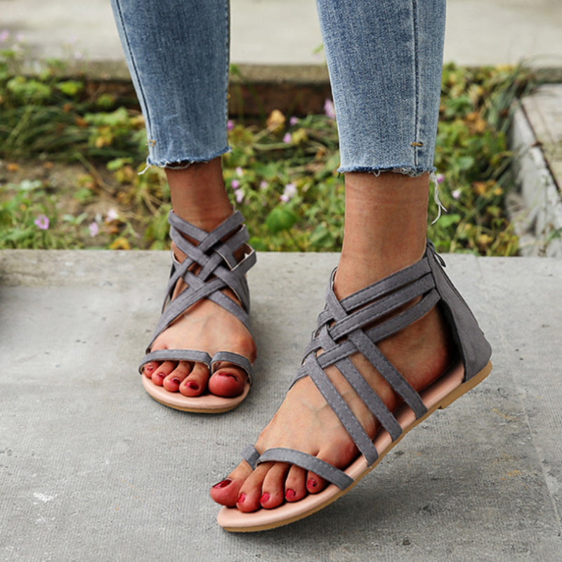 "Kvinnors platta sandaler med dragkedja, korsband och PU-material för sommar. Perfekt för en stilfull och bekväm look."