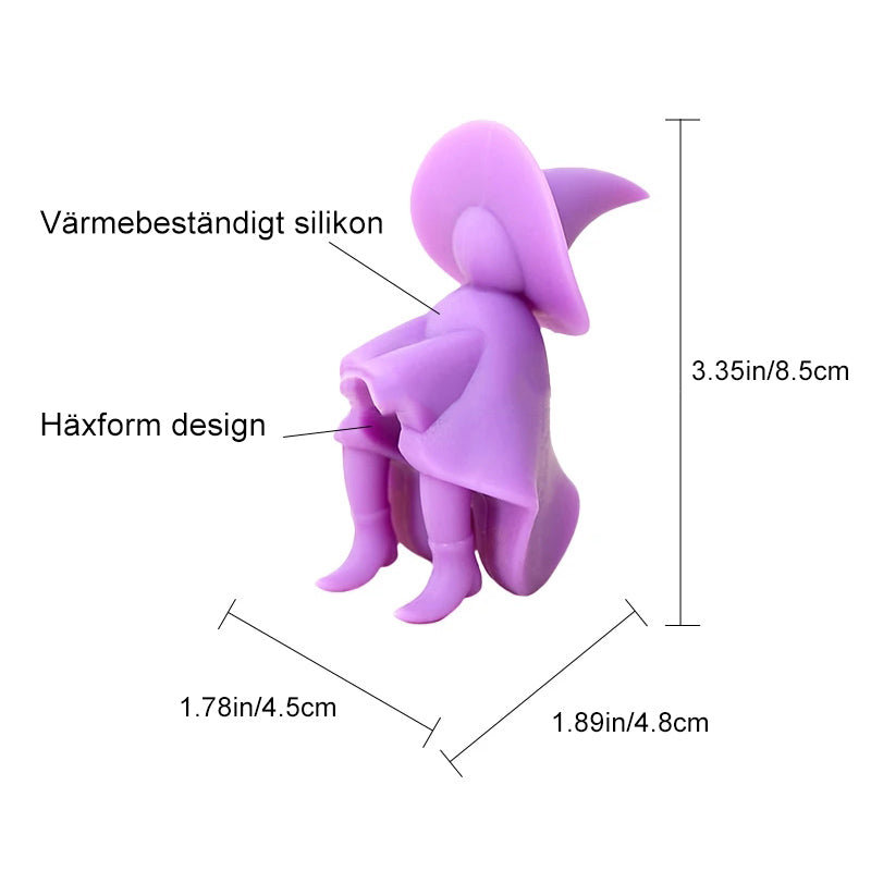"Lila silikon häxskedhållare för kök med unik design, praktisk och hygienisk, liggande på en köksbänk."