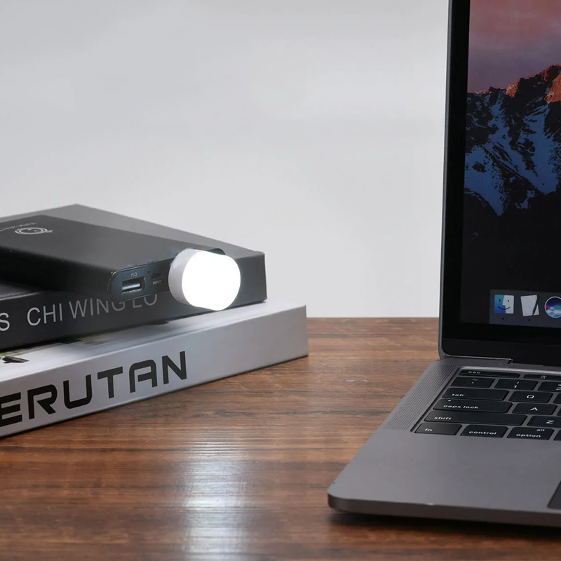 Liten USB LED nattlampa med ögonskydd, kompakt och stilren, avger mjukt vitt ljus, perfekt för sovrum och resor.