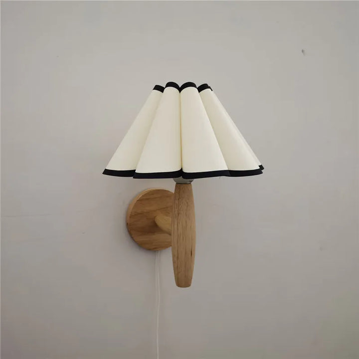 Lyren vägglampa som heminredning: Skapar varm atmosfär med nordisk design, trä och plisserad skärm.