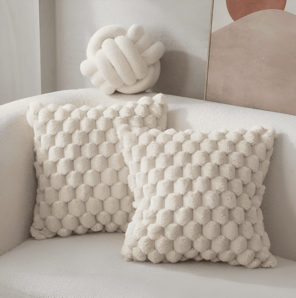Modernt fluffigt kuddfodral med unikt mönster. Mjuk textil ger lyxig känsla till heminredning i vardagsrum.