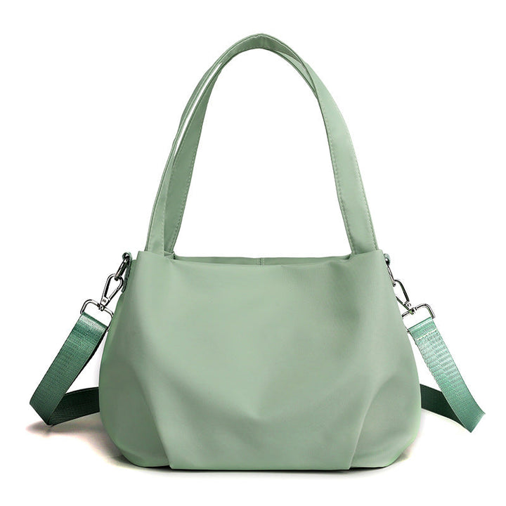 "Mångsidig nylon crossbody väska för kvinnor med ficka, justerbar rem och fler färgval, perfekt för vardag och resor."