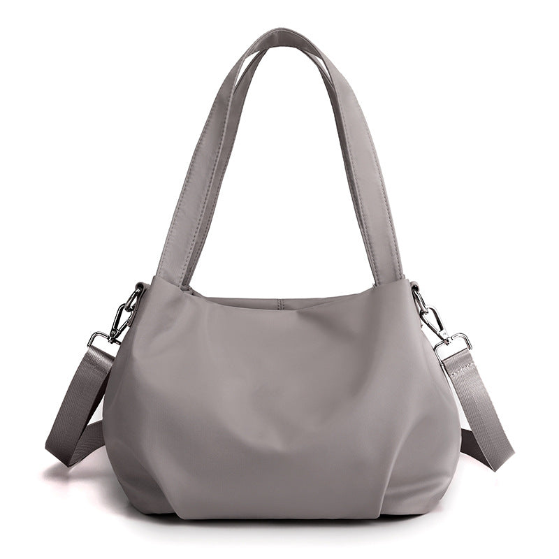 "Mångsidig nylon crossbody väska för kvinnor med ficka, justerbar rem och fler färgval, perfekt för vardag och resor."