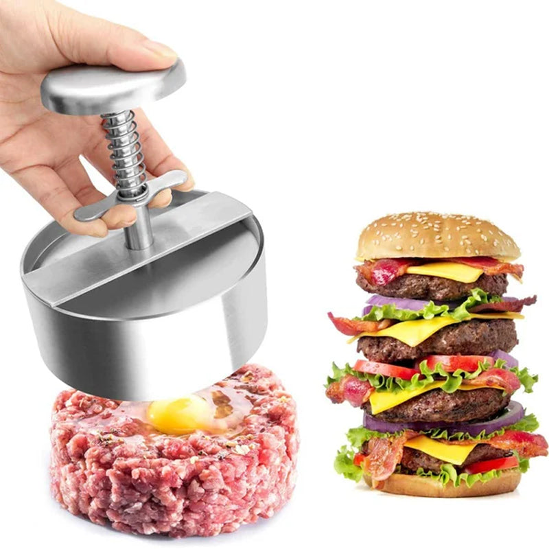 "Manuell köttpress i rostfritt stål, silverfärgad, ergonomisk design för perfekta hamburgerplättar, köksredskap."