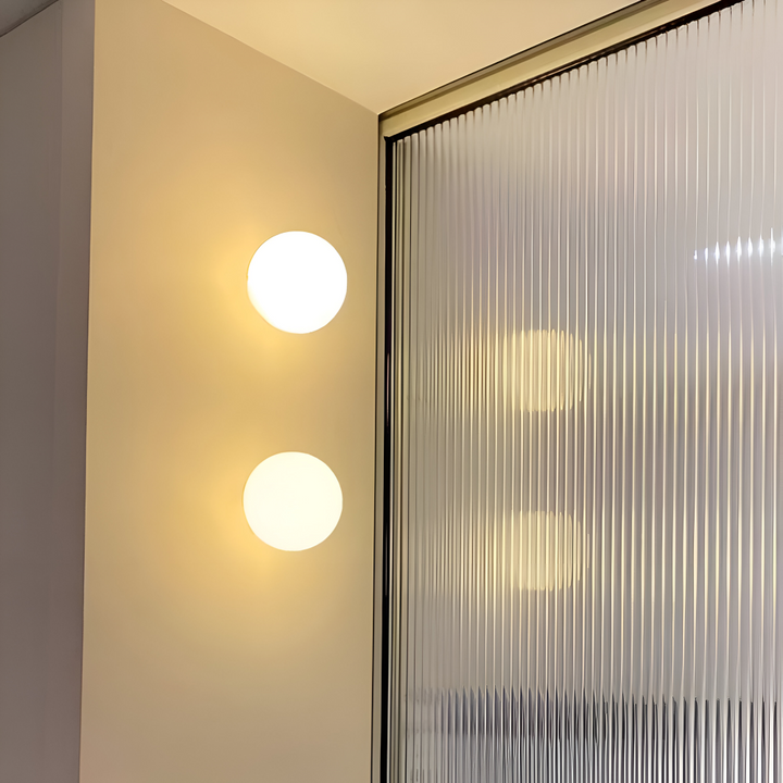 Väggmonterad rund lampa i glas med LED-teknik, modern inredningsdetalj.