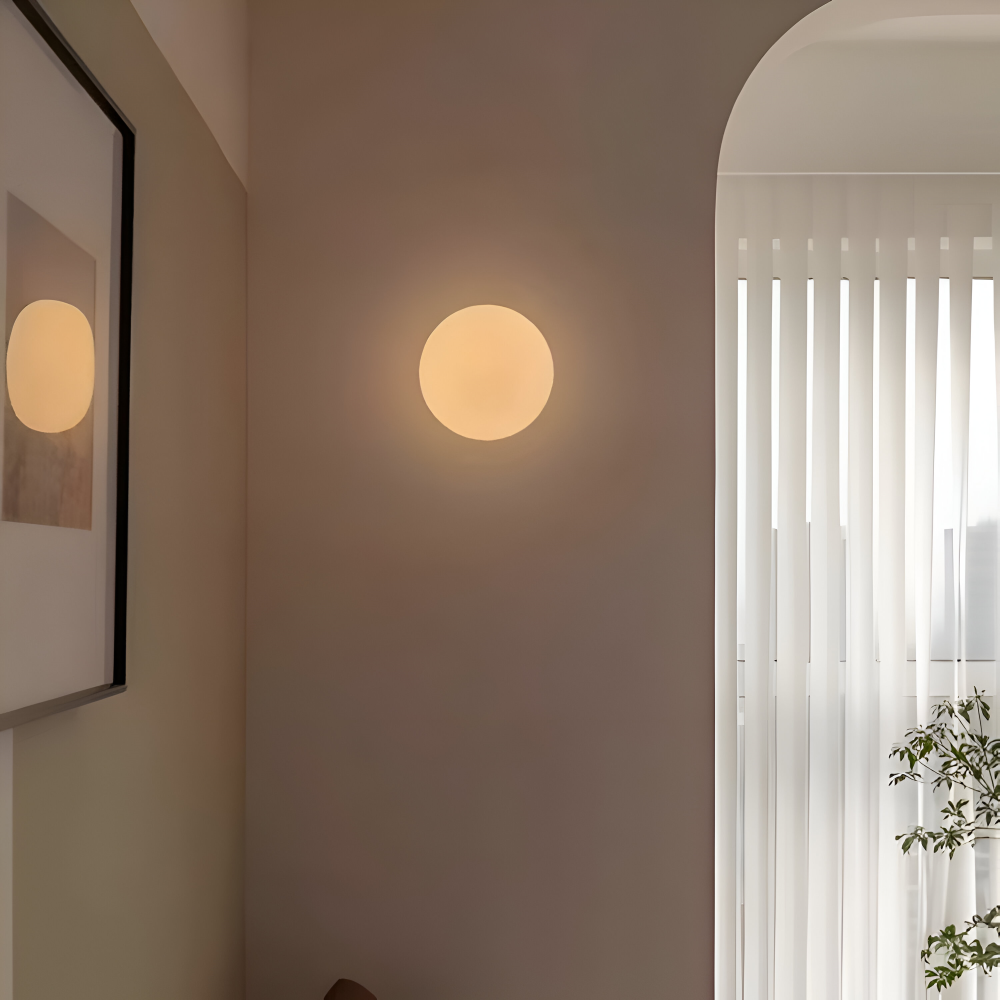 Enkel men elegant rund vägglampa i glas med inbyggd LED-belysning.