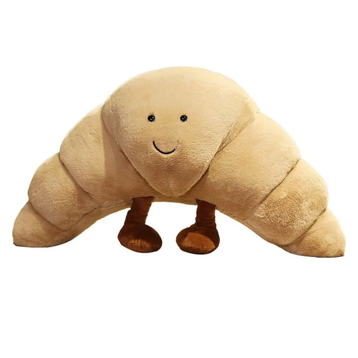 Barn leker glatt med den mjuka, skrattande croissant kramkudden, ett roligt plyschdjur.