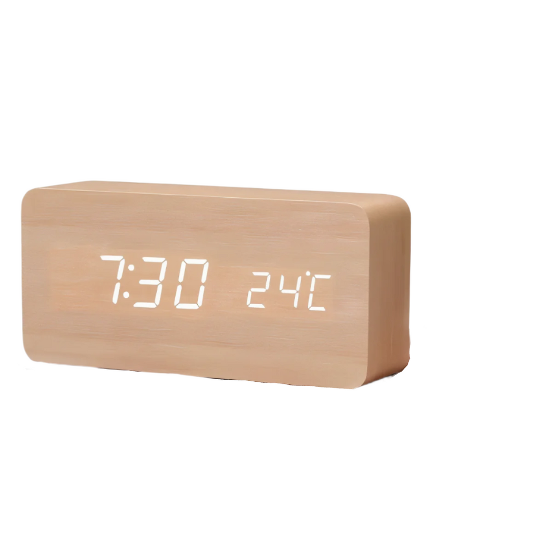Toppvy av digital LED-väckarklocka med diskreta kontroller. Modern design för hemmets ytor.