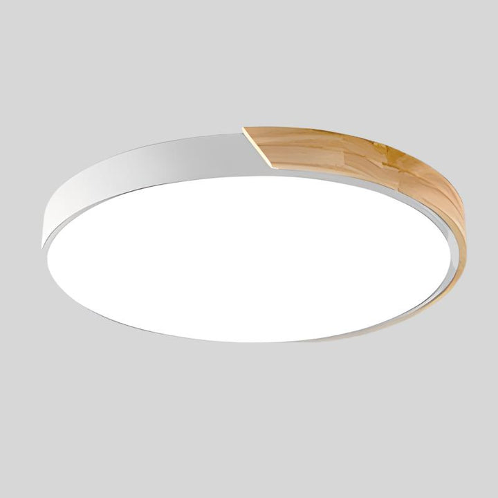 Modern rund LED-taklampa med varmvit belysning, designad för stilfull inredning.