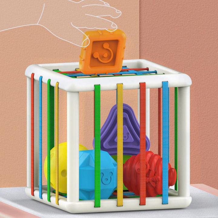 Multifärgad pedagogisk barnleksak med sensoriska funktioner, runda hörn och elastiska rep för småbarns utveckling.