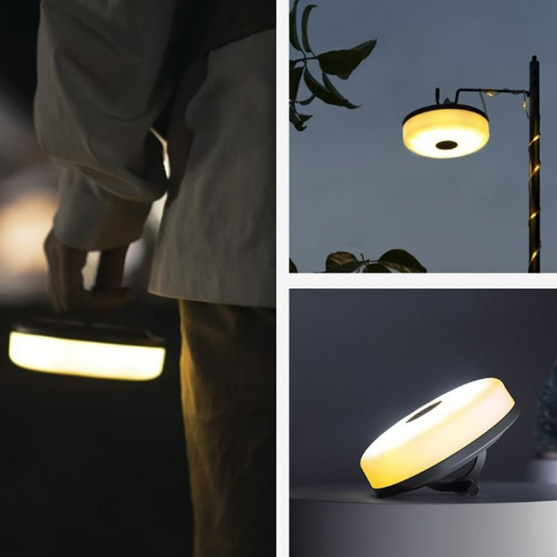 Multifunktionell bärbar campinglampa med IP67-skydd, USB-laddning, lädersnöre och ljusbälte för utomhusbruk.