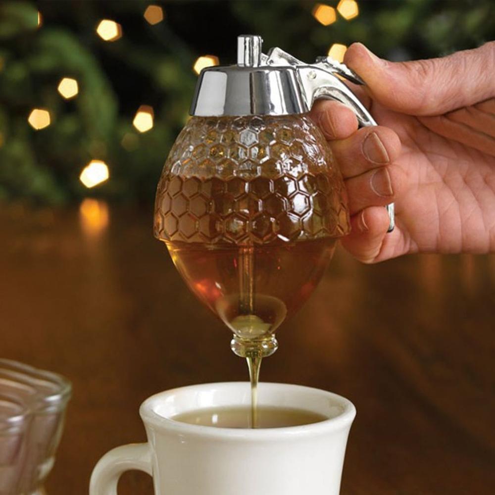 "Multifunktionell smidig honungsdispenser i glas med kromdetaljer för köket, eliminerar spill och klibbighet."